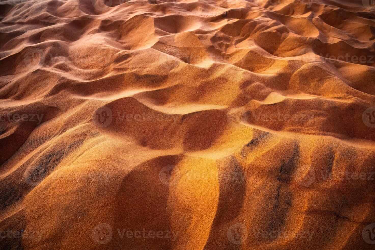 Shiny wavy golden sand dune pattern in the sunset photo