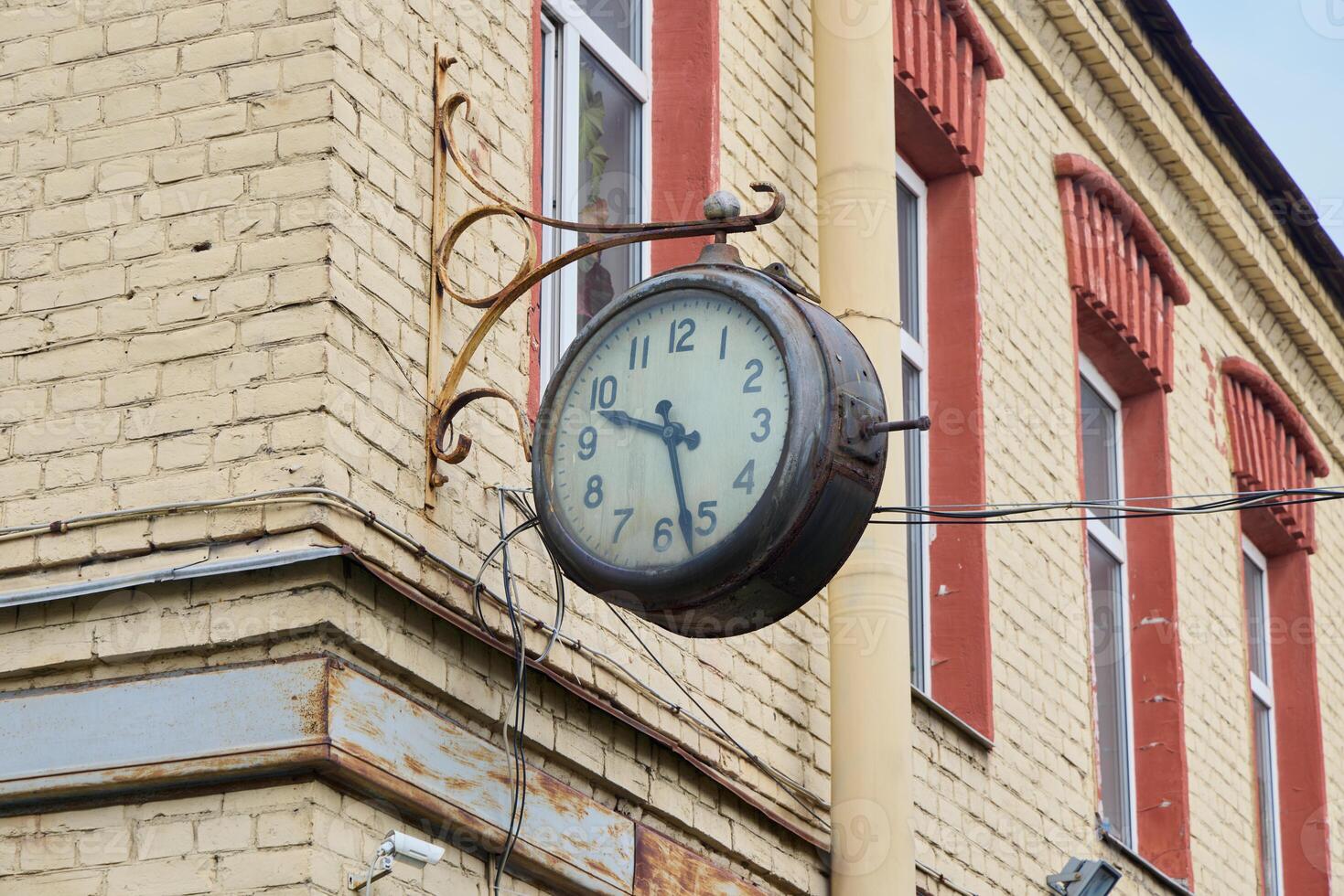A breathtaking Vintage Wall Clock is showcased beautifully on a Historic Building facade photo