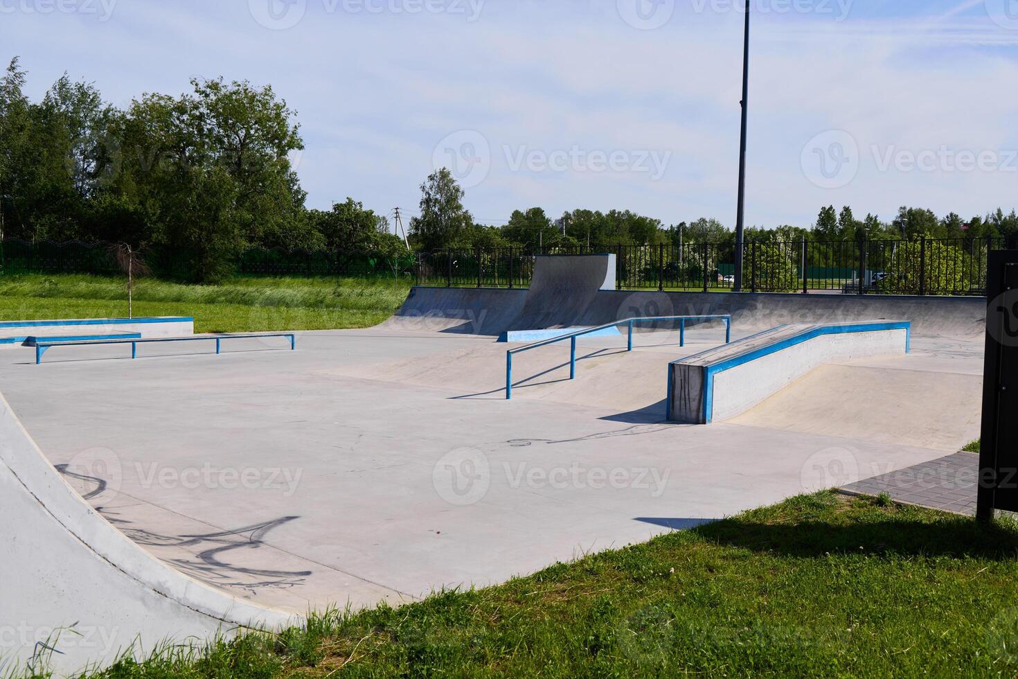 A Vibrant Skatepark Featuring Ramps and Rails Under the Radiant Sun on a Perfect Day photo