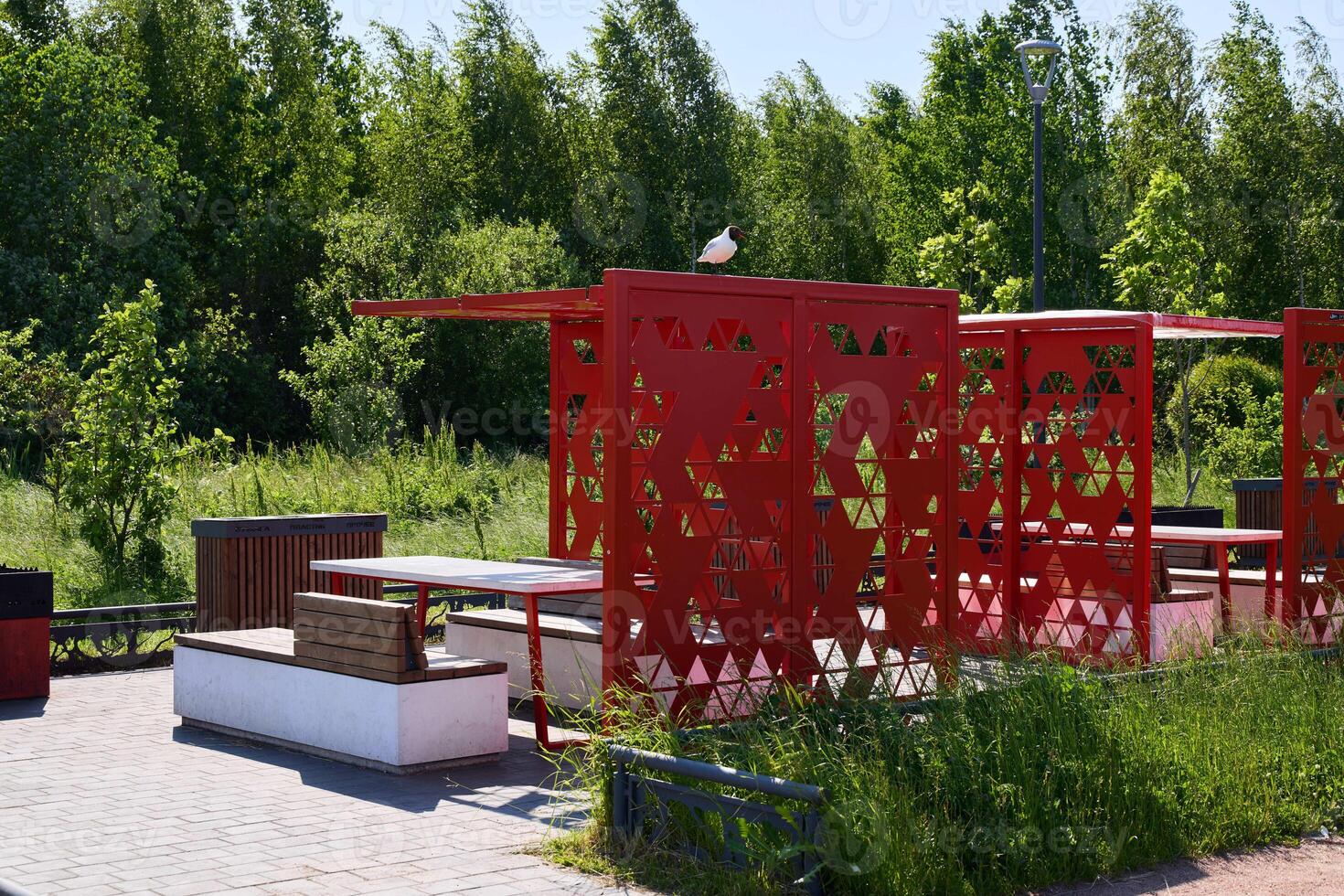 Modern Outdoor Pavilion Featuring an Artistic Design Set Amidst a Lush Green Environment photo