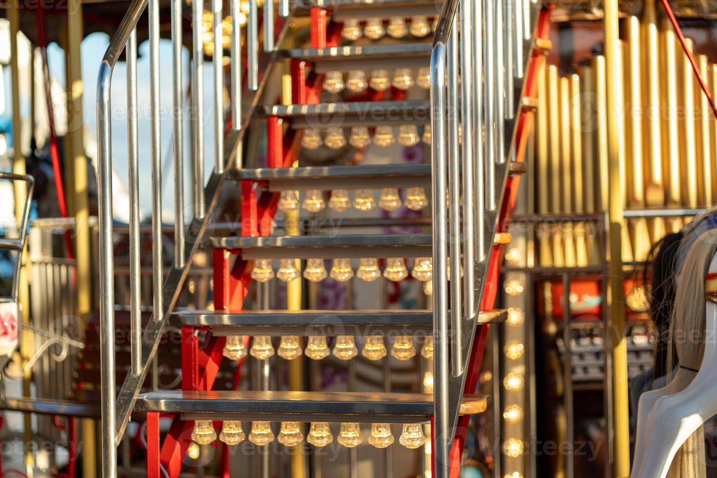 Stairs Leading to a Colorful Carousel Adorned With Lights During Late Afternoon photo