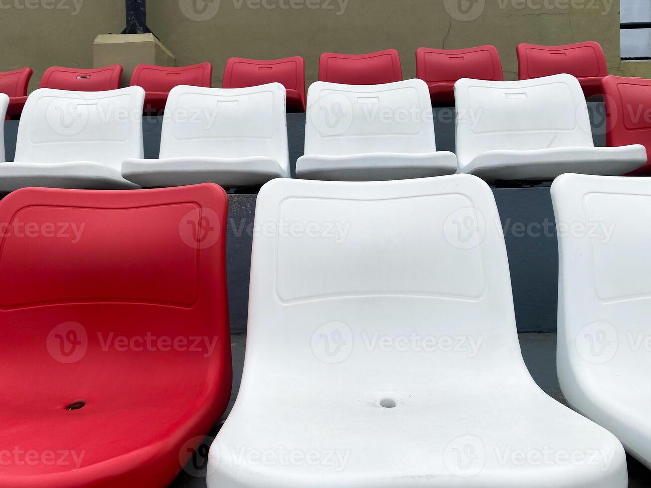 Rows of Red and White Stadium Seats Awaiting Spectators photo