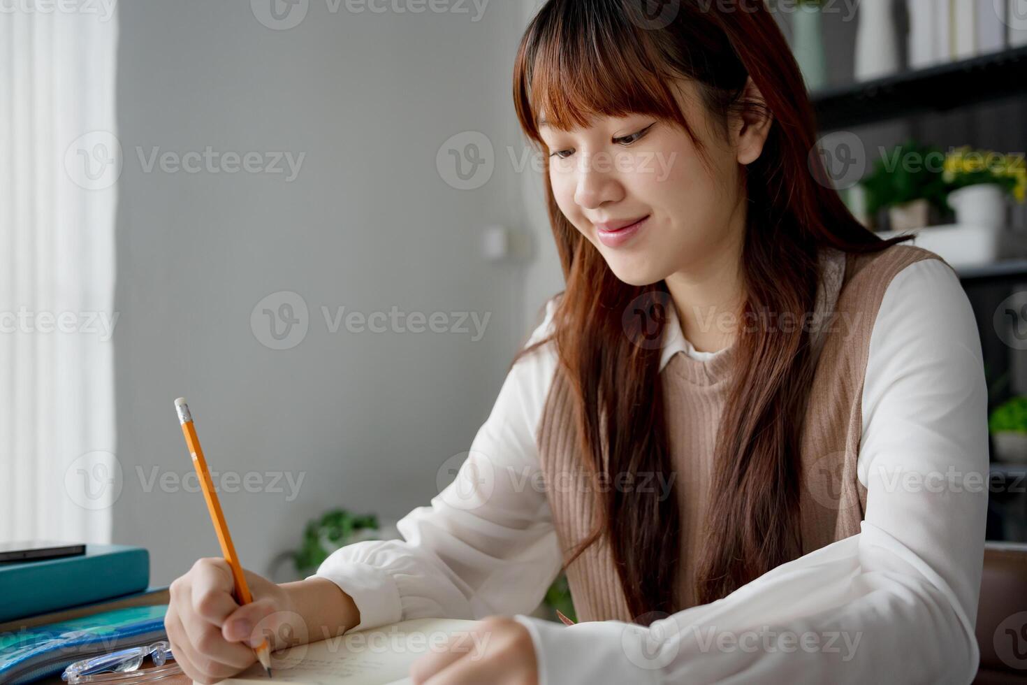 Asian student woman using laptop to study student in online learning. photo