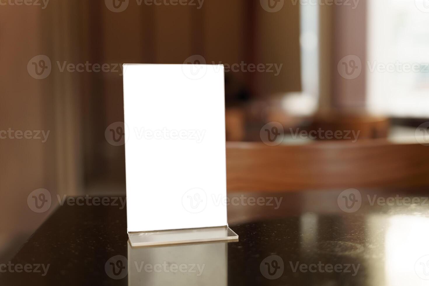 Mock up Menu frame standing on wood table in restaurant for text. photo