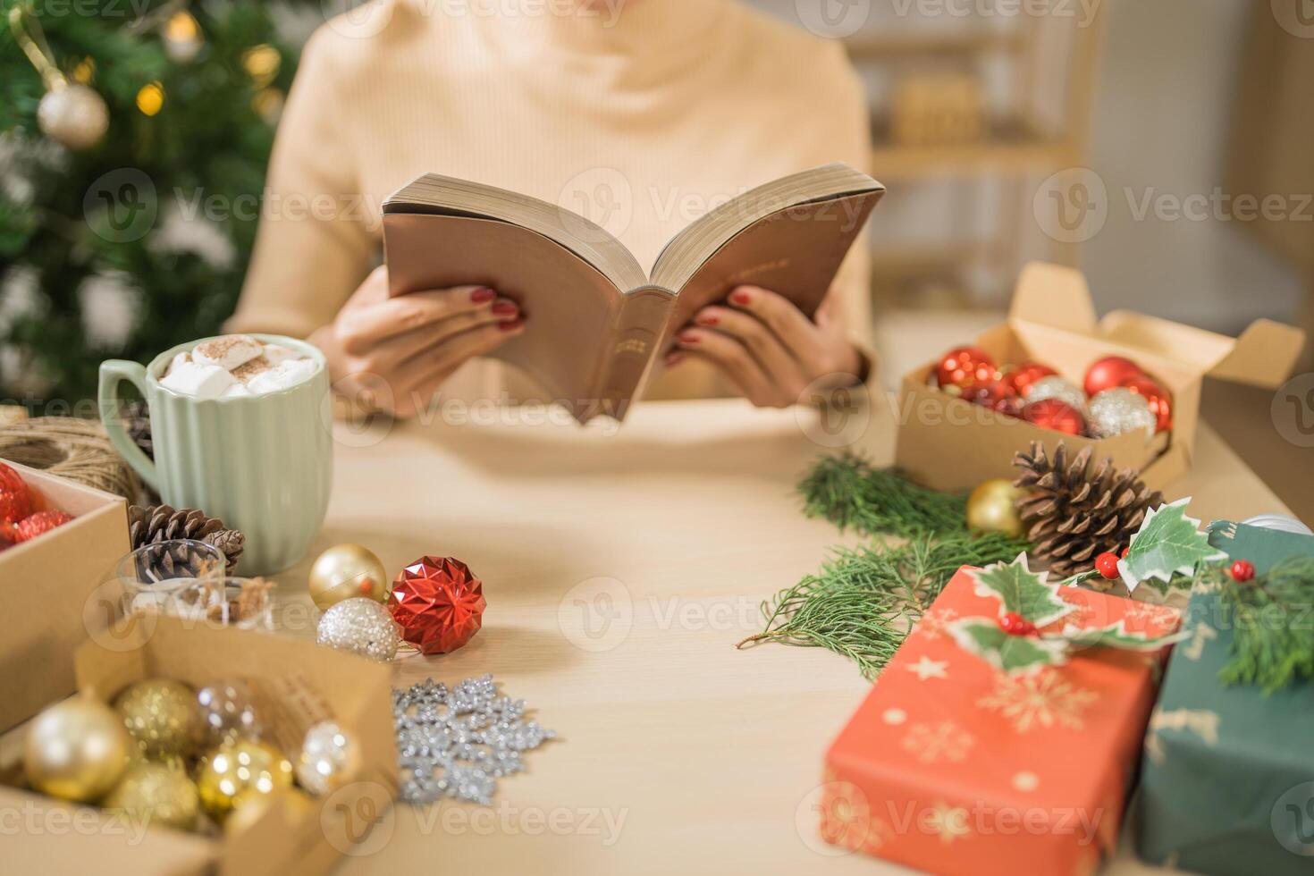Happy woman reading book celebrating christmas at home relax Xmas holiday photo