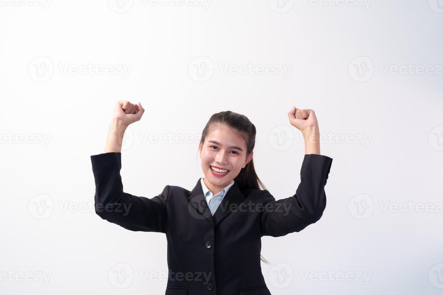asian Happy Beautiful business woman with arms up in victory pose photo