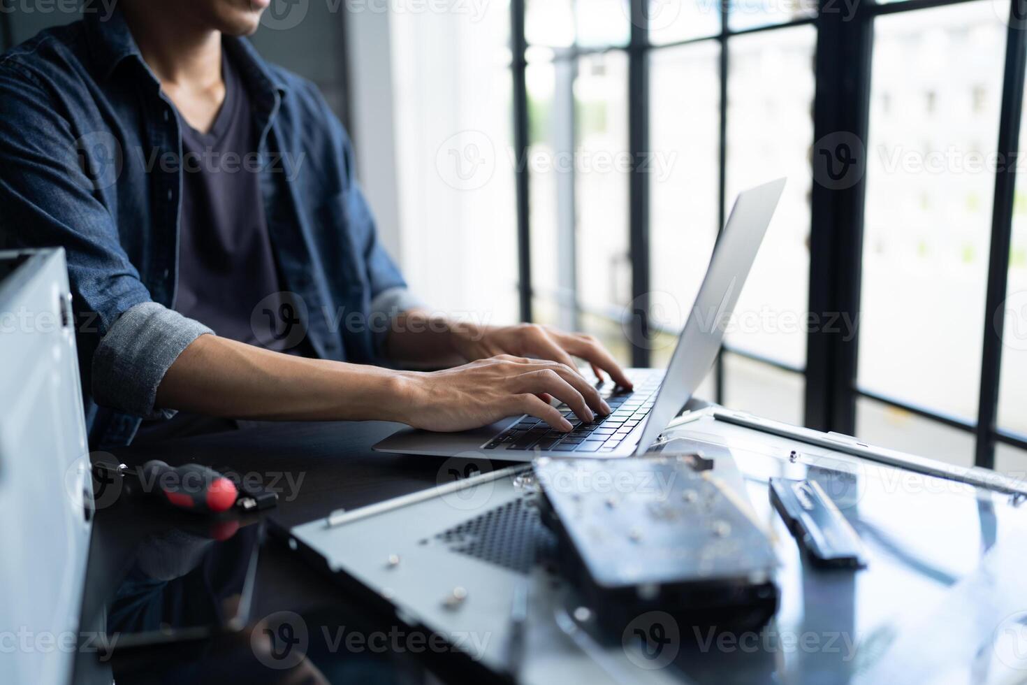 a Engineer man is typing on a laptop computer photo