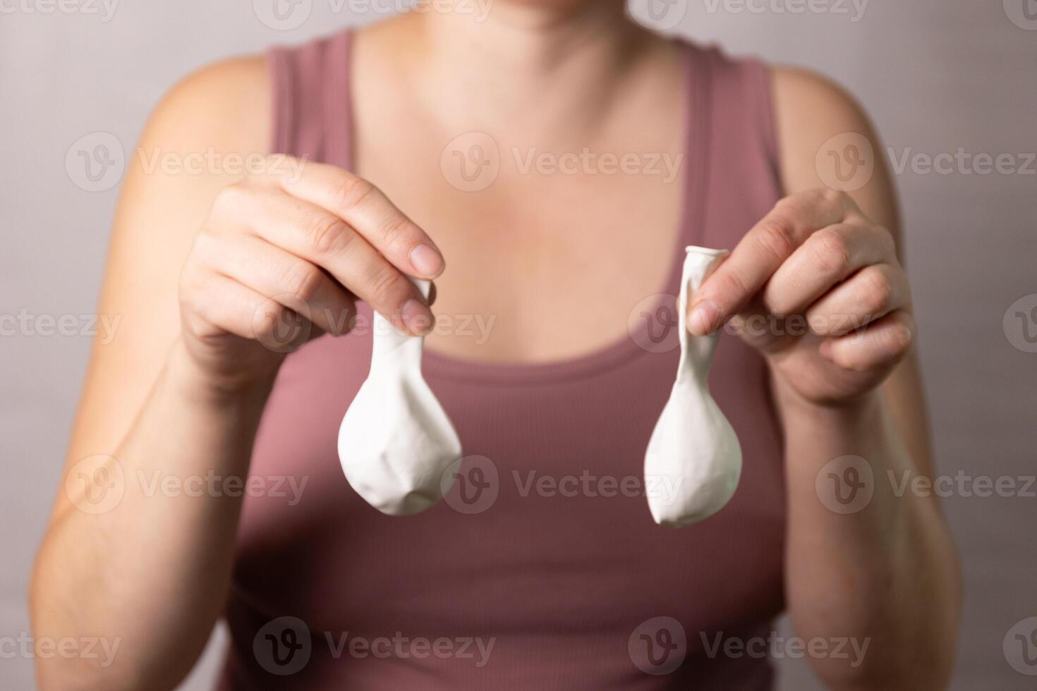 The concept of age-related changes in the female breast, demonstrating sagging breasts photo