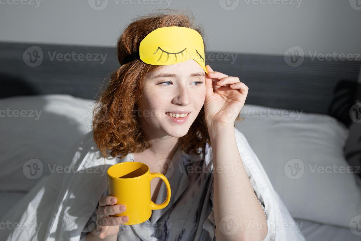 Morning Routine Including a Young Woman Enjoying a Warm Drink in Cozy Bedroom Setting photo