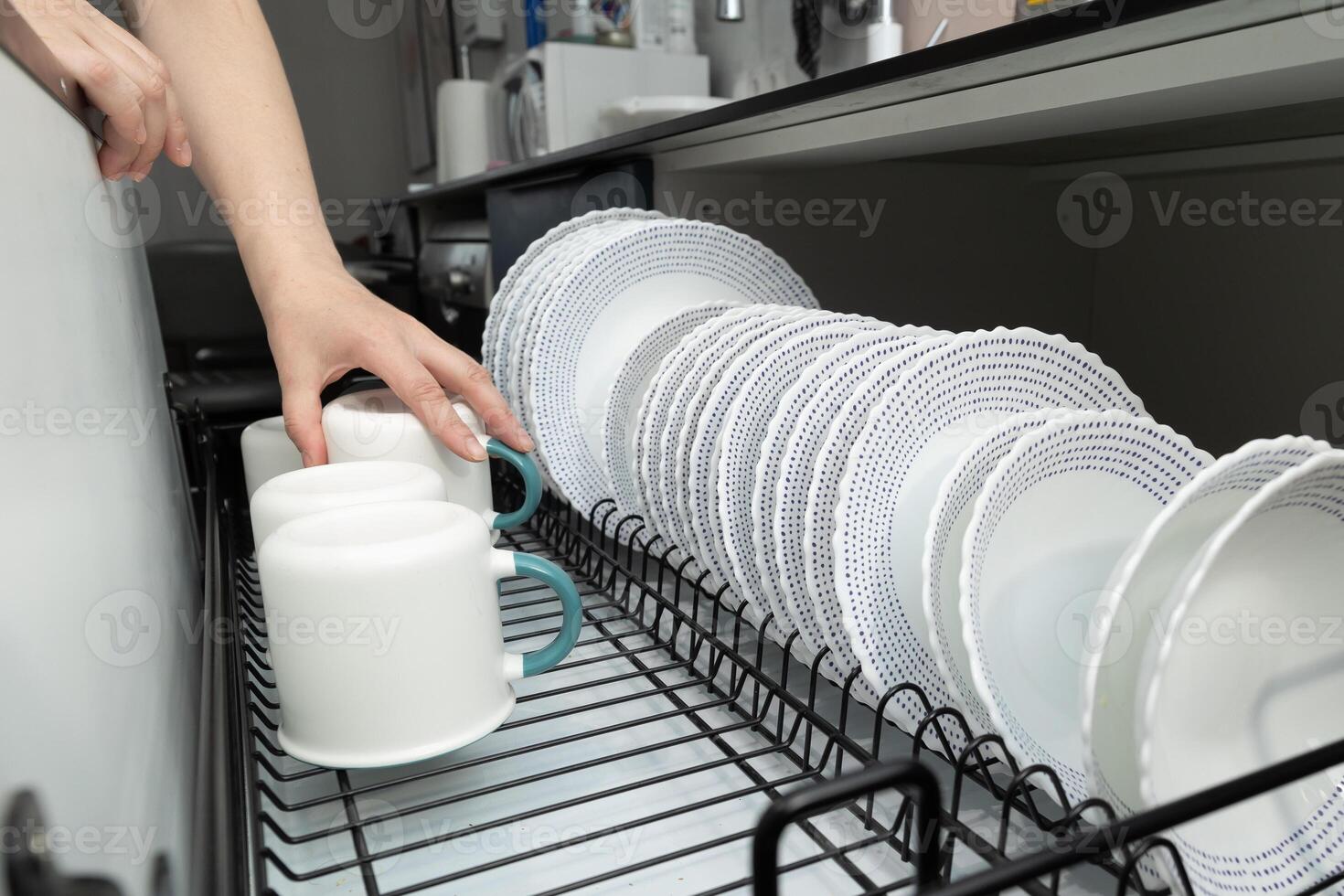 Person Cleaning Dishes in a Modern Kitchen at Day photo