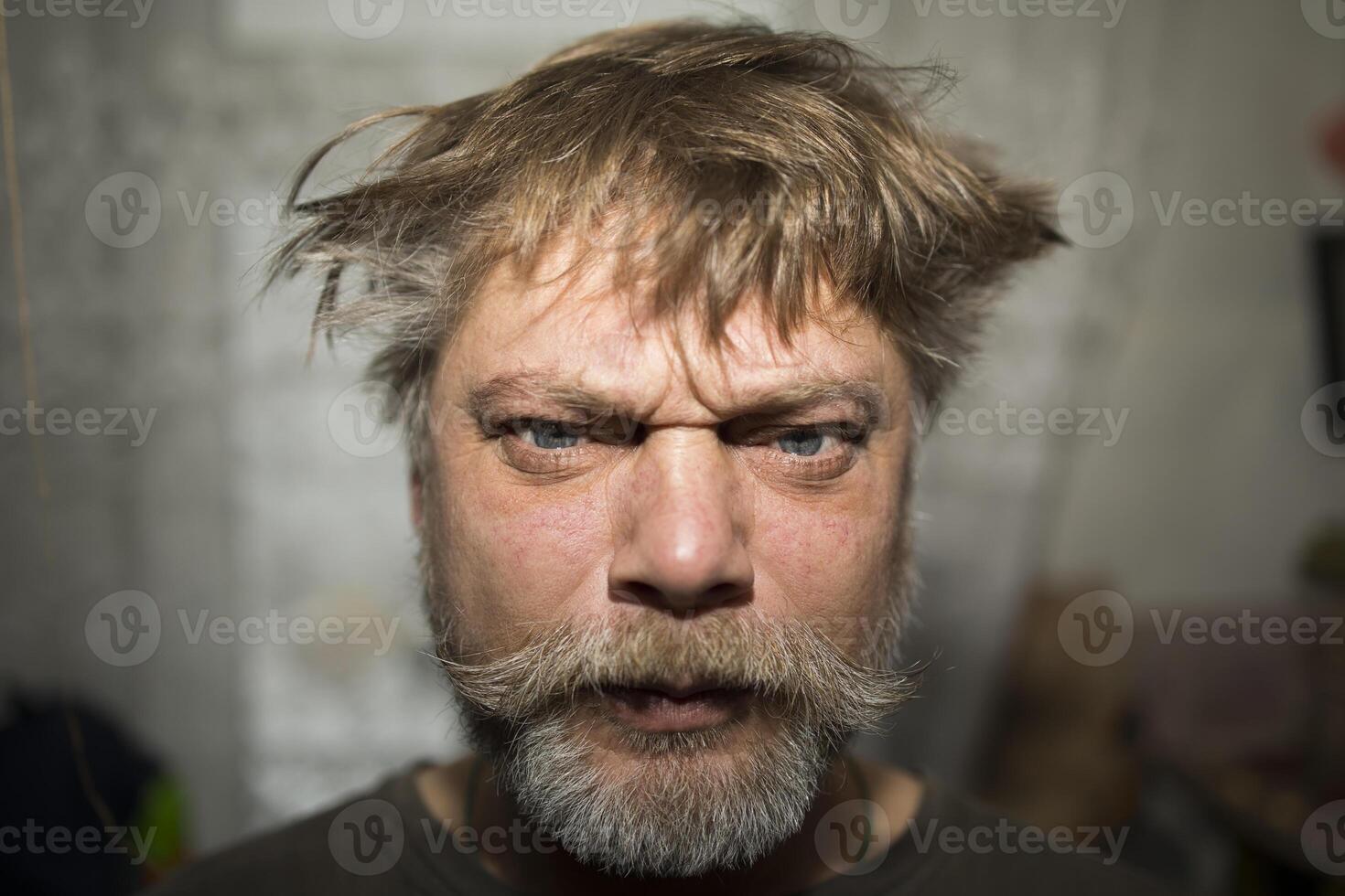 Man with facial hair and a smile looking at the camera in a portrait photography photo