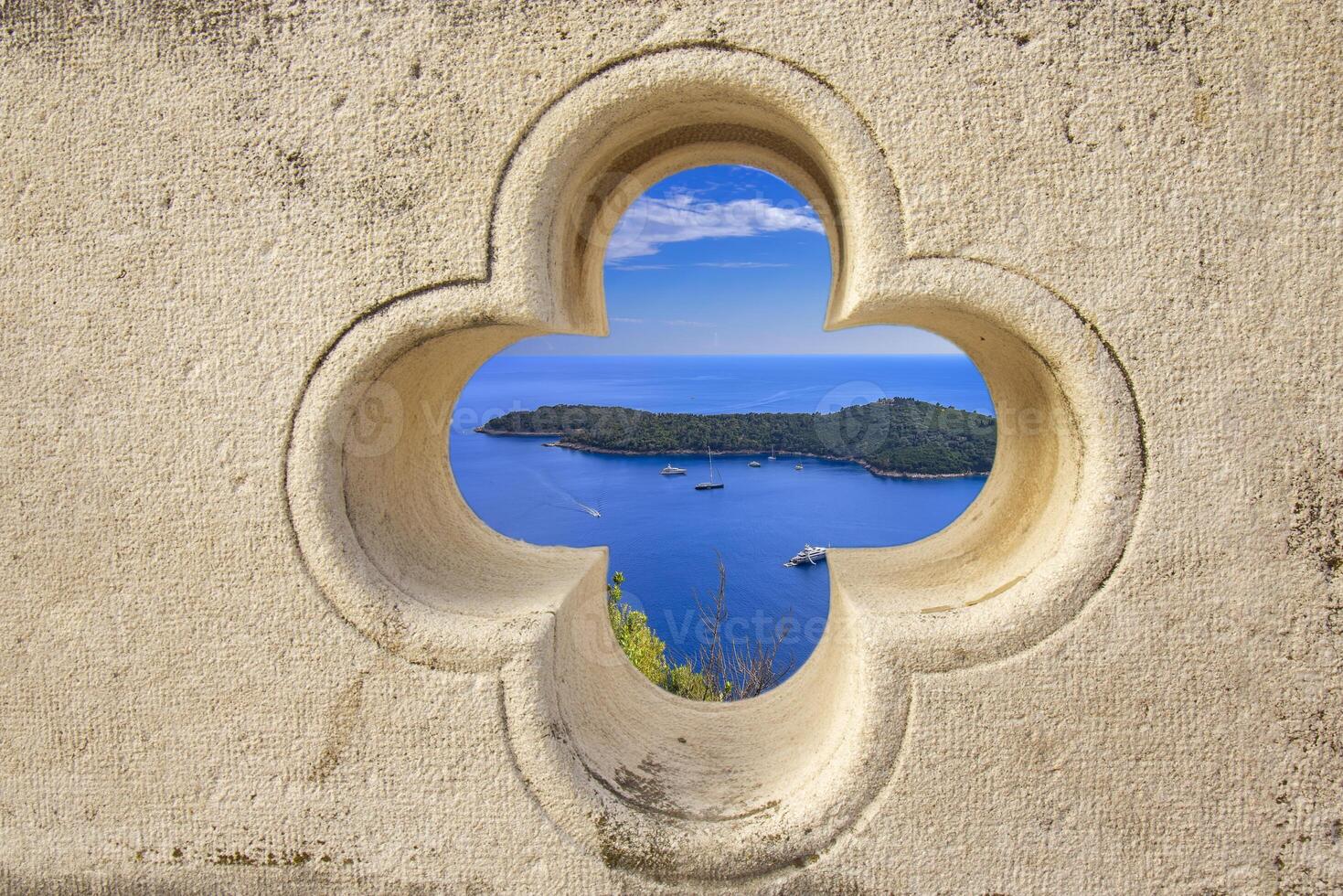 Island near Dubrovnik through stone window view photo