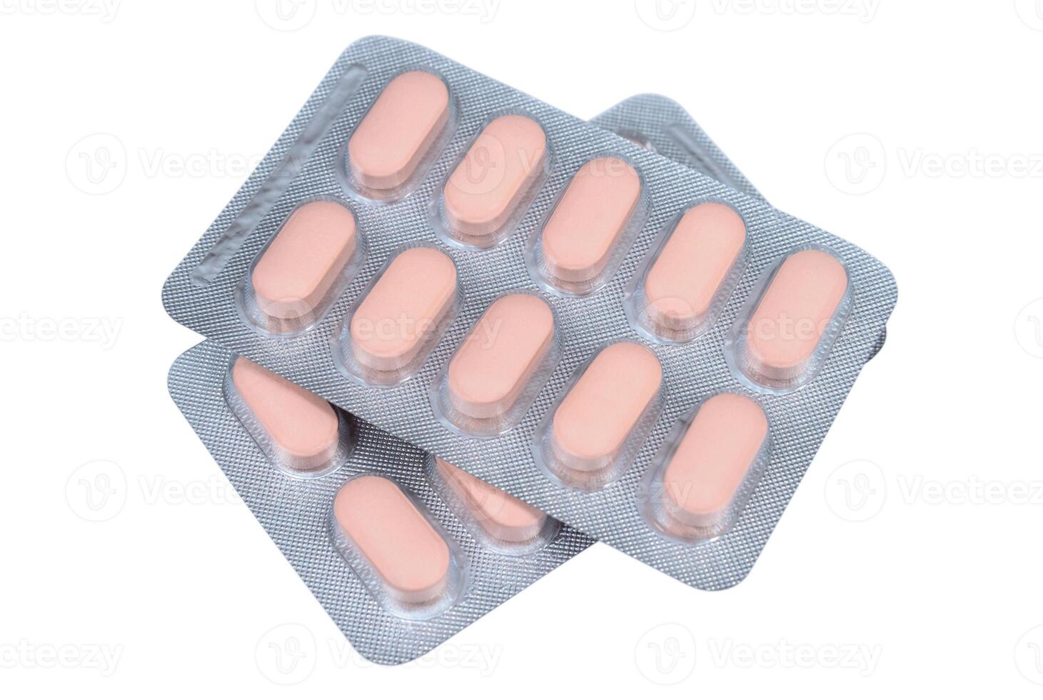 Pink pills in a blister pack on a white background photo