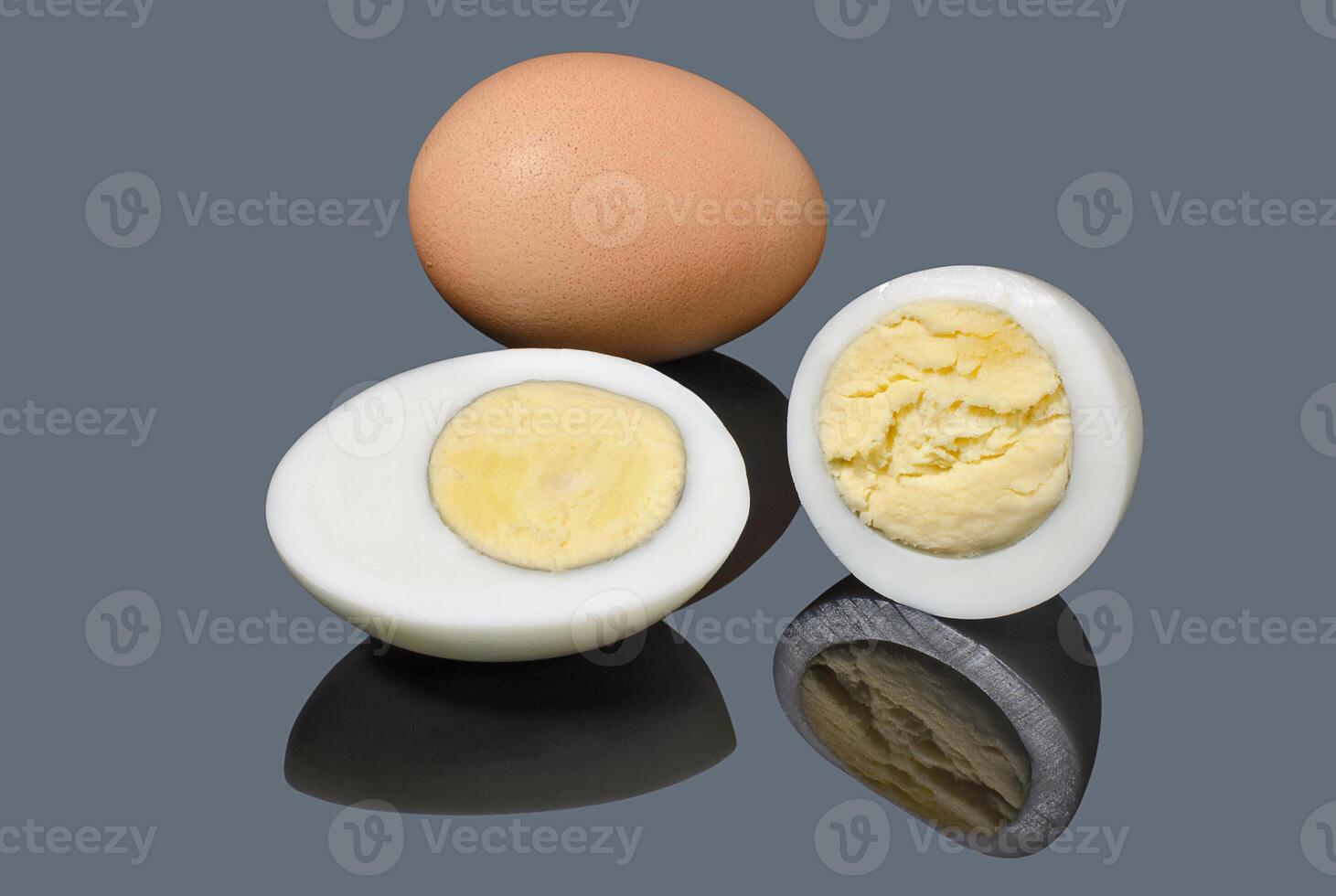 Slice boiled chicken eggs on gray background photo