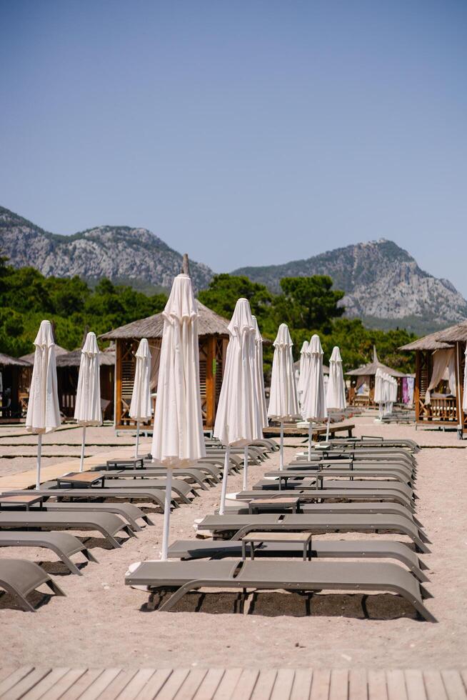Beautiful empty beach with sun loungers. photo