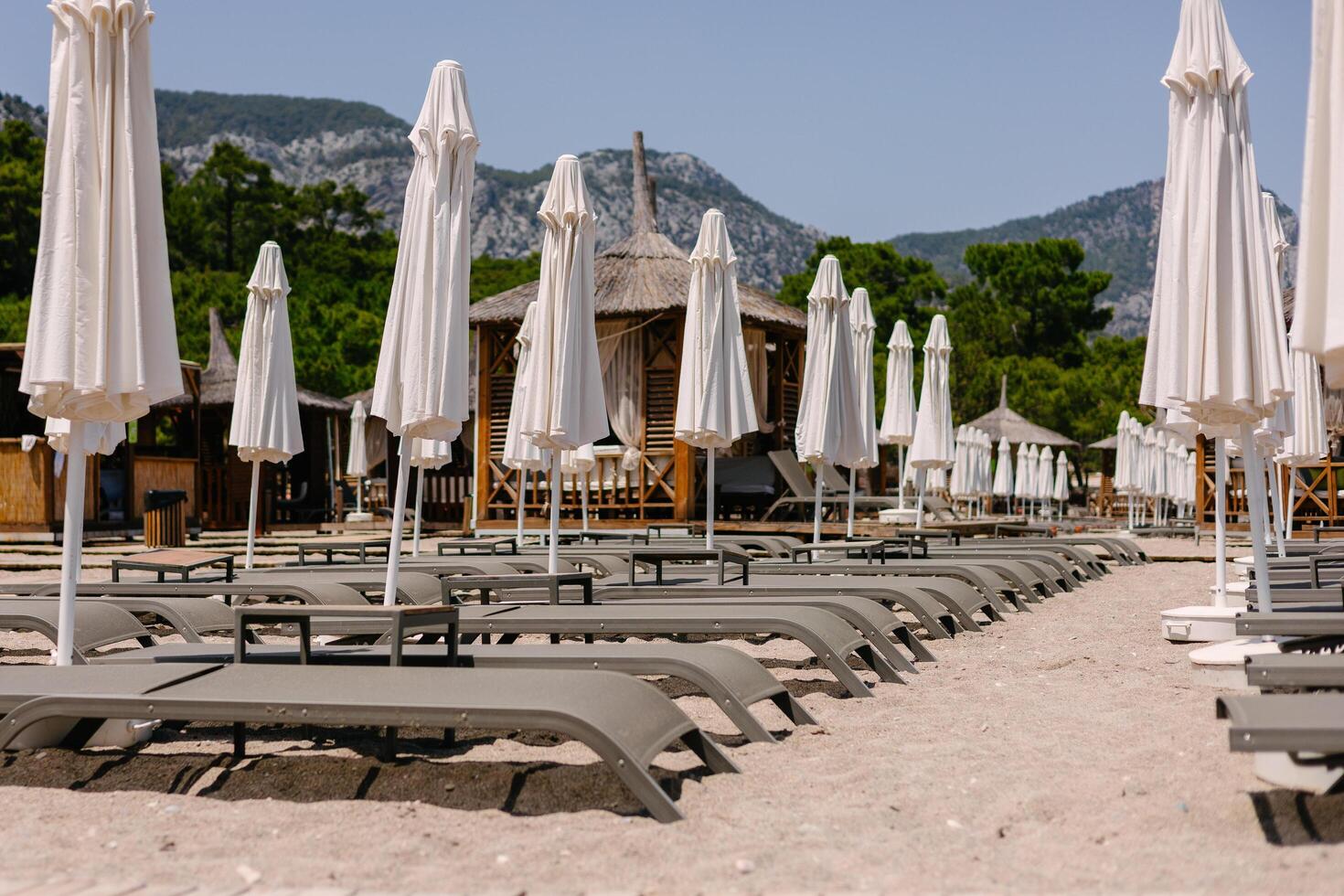 Beautiful empty beach with sun lounger photo
