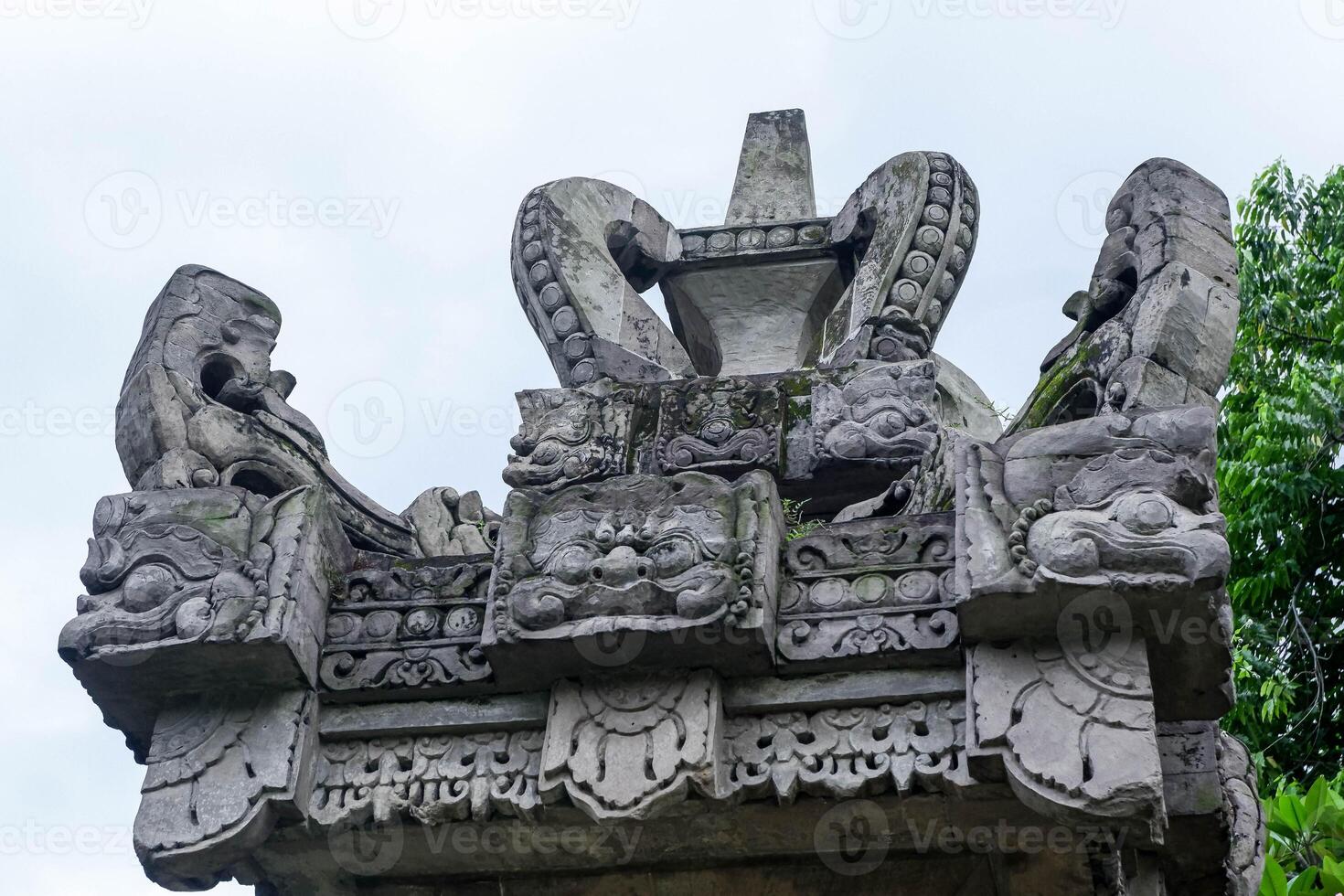 Detail of traditional Balinese temple stone carvings with sacred ornamentation, showcasing cultural and spiritual architecture from Bali, Indonesia. photo