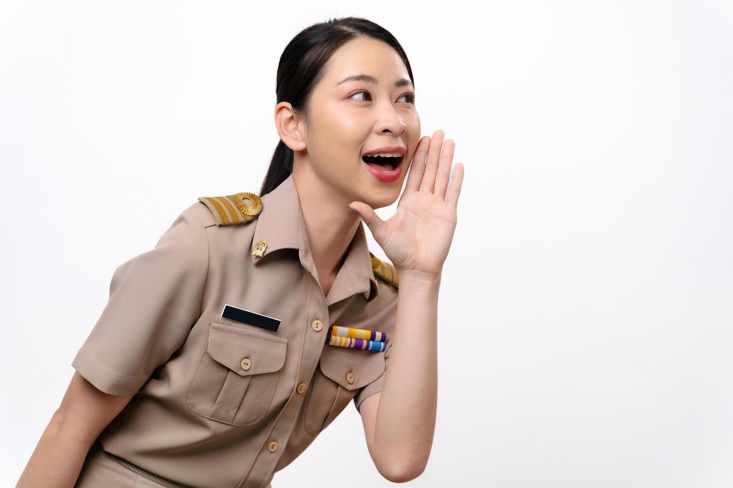 Woman in a Thai asian teacher uniform is open mouths raising hands to announcement photo