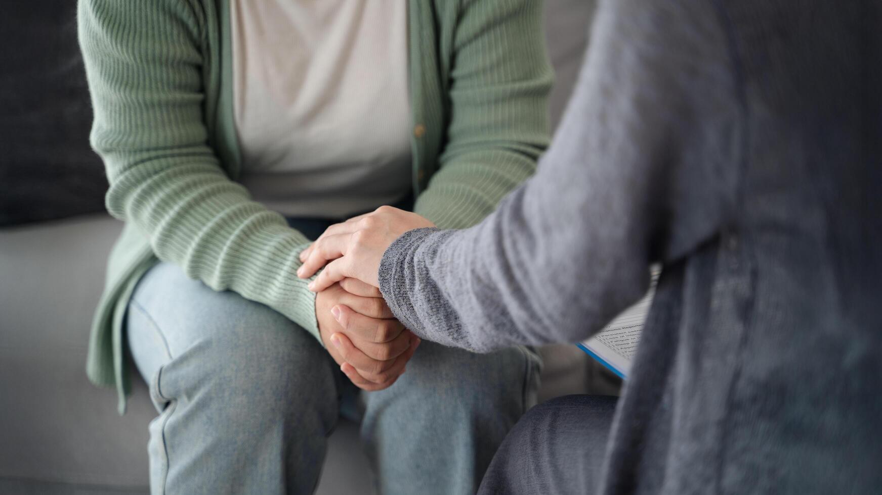 Psychologist or family holding hands to encourage patient with depression, anxiety, therapy photo