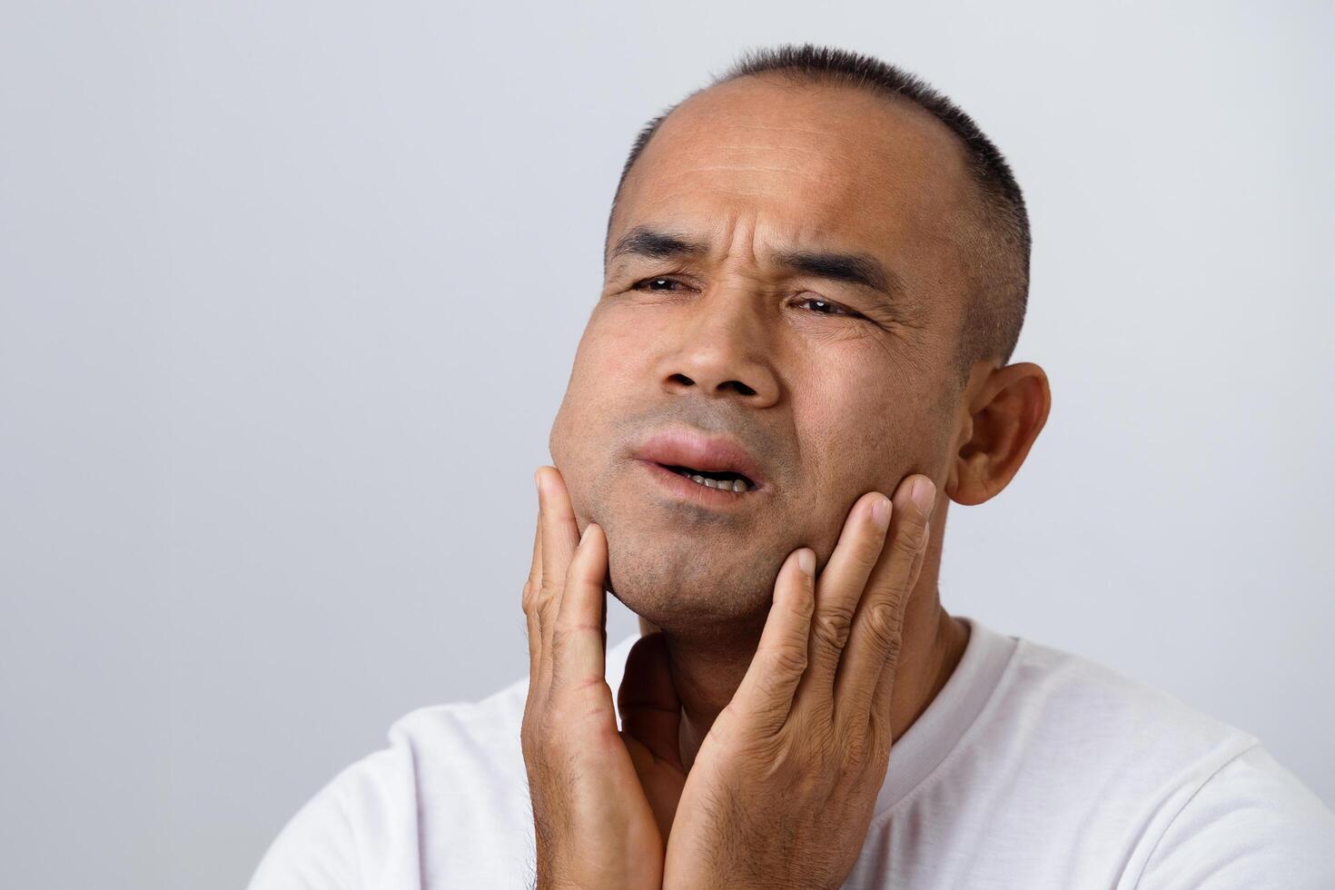 Man has facial swellen due to an allergic reaction to triggers such as insect bites, food photo