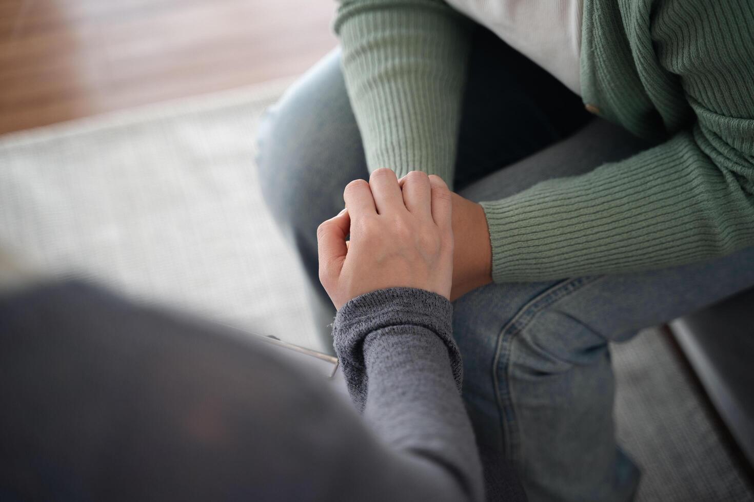 Psychologist friend or family holding hands to encourage patient with depression, anxiety, therapy photo