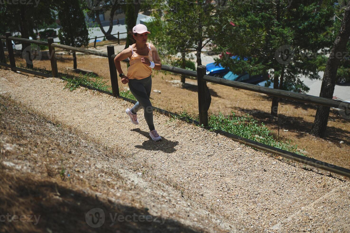 Young Woman Jogging on an Outdoor Path Surrounded by Nature photo
