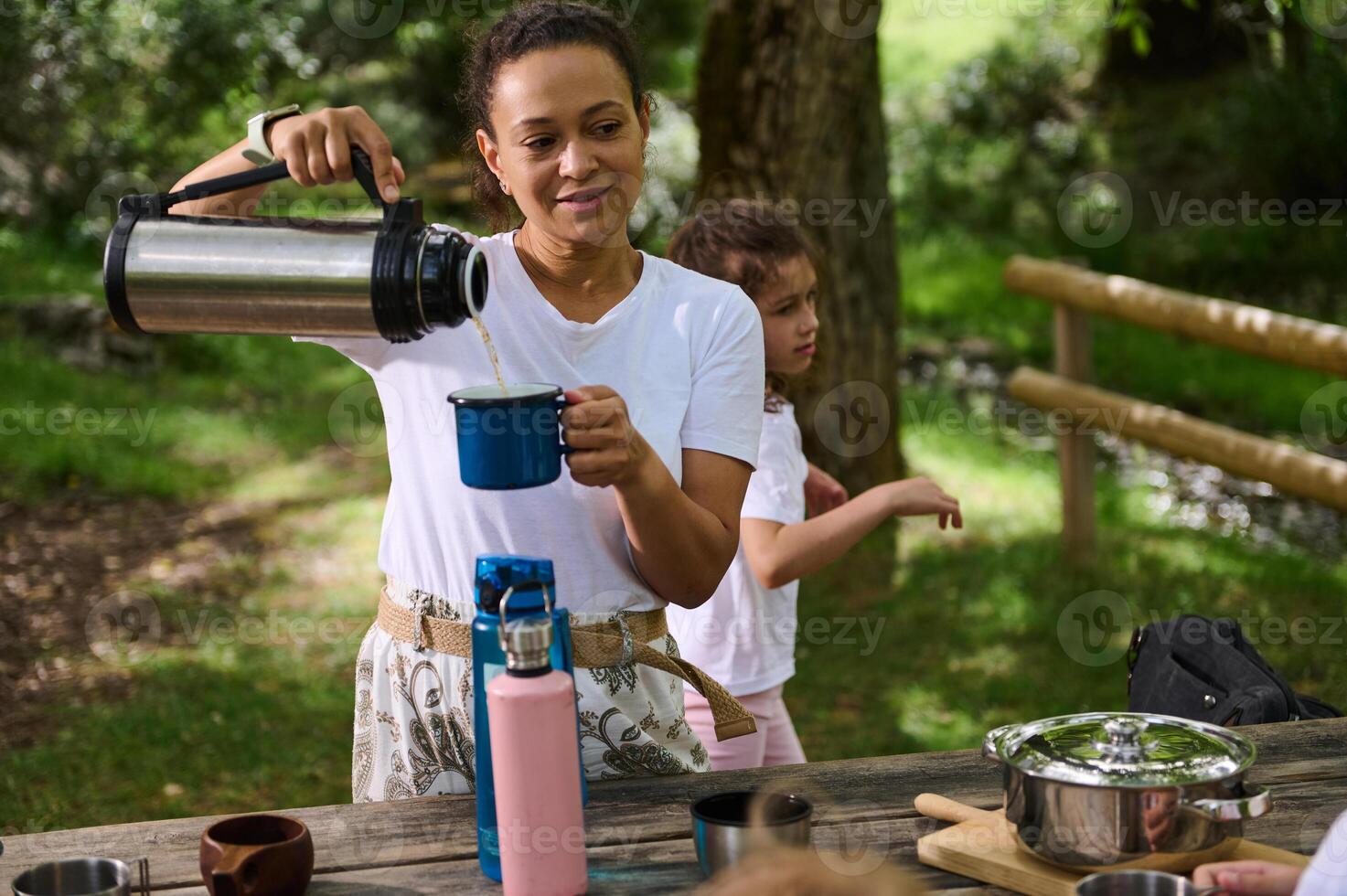 Family Enjoying a Relaxing Outdoor Picnic at a Scenic Park photo