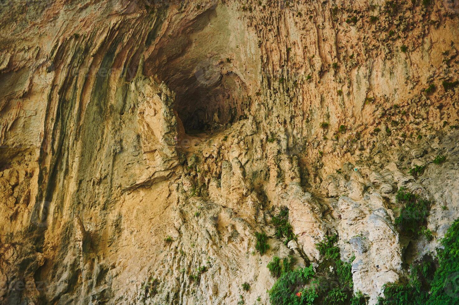 Natural Cave Texture with Unique Shapes and Greenery photo
