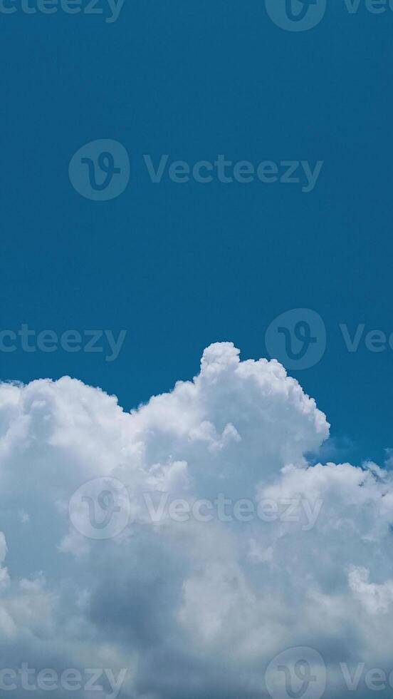 A plane flying in the sky with a cloud in the background photo