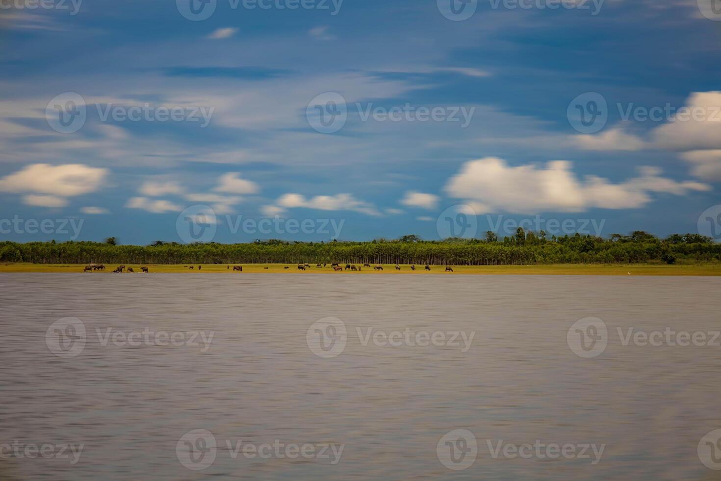 A peaceful reservoir surrounded by snow-capped mountains. photo