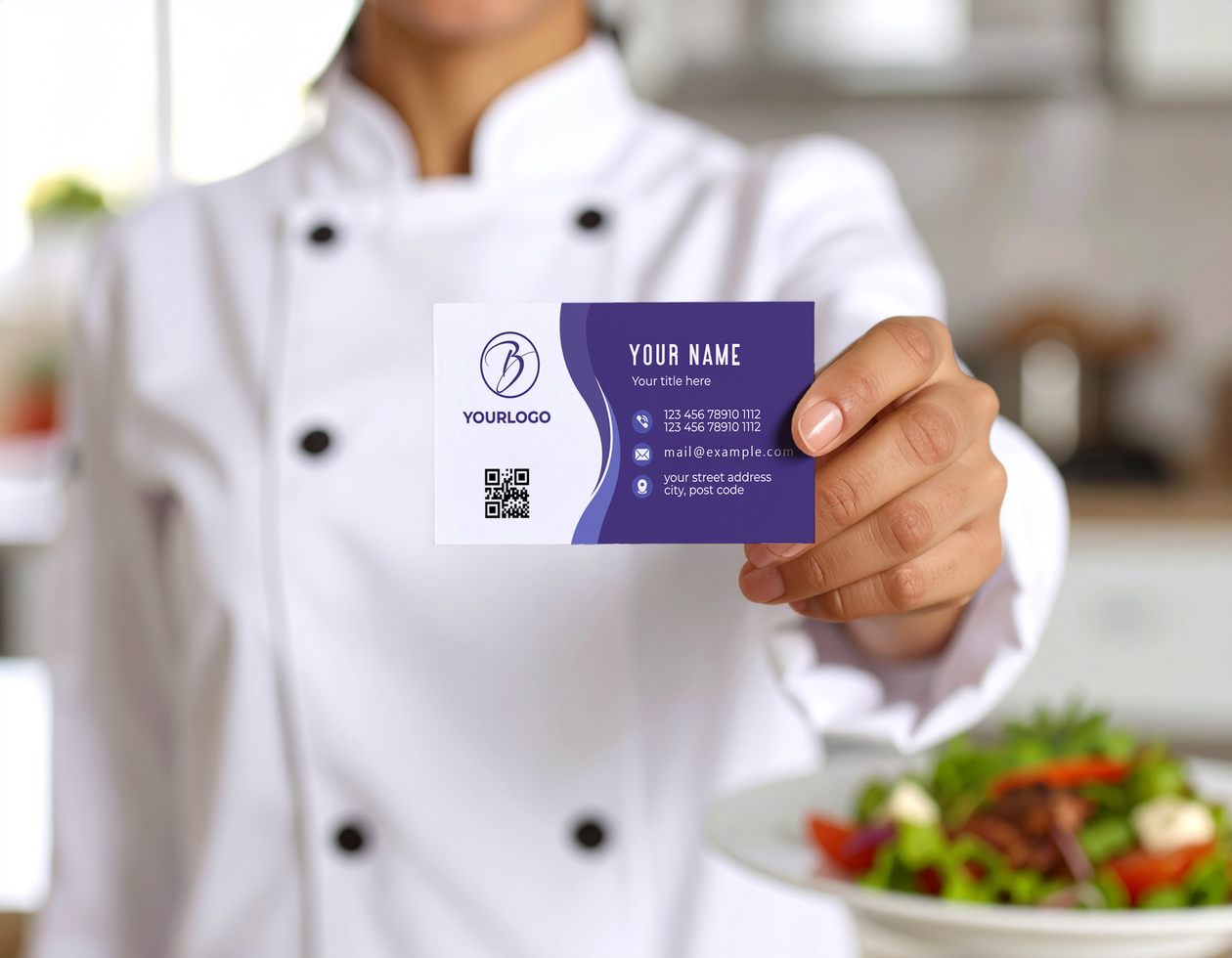Chef in Uniform Showcasing Business Card Mockup psd