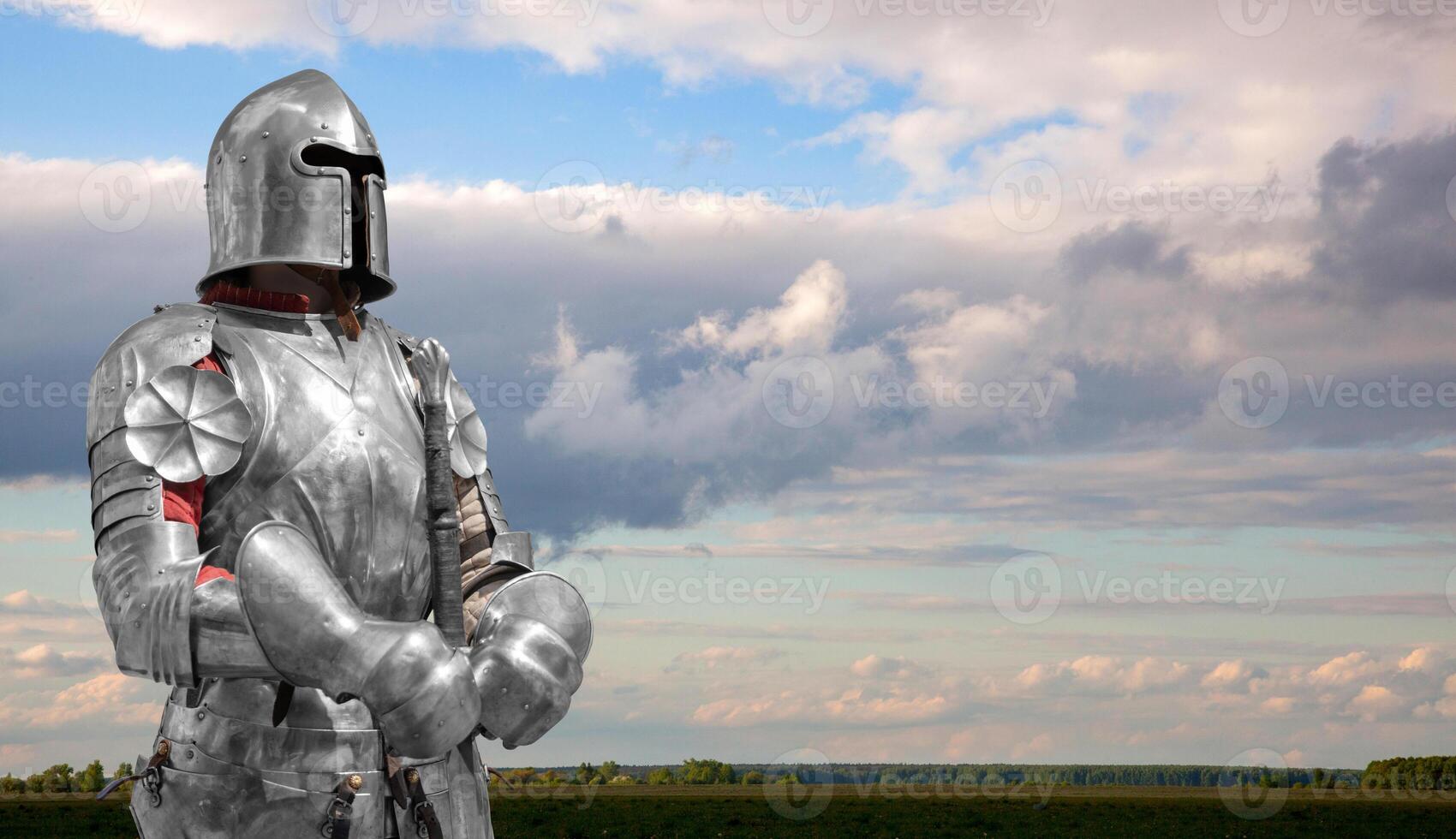 Medieval knight against the background of beautiful clouds. photo