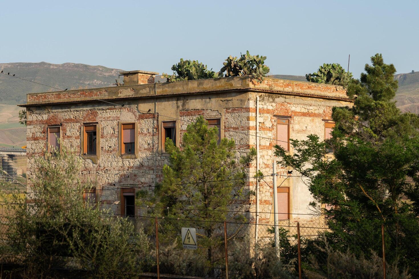 Abandoned building with cactuses in it, Sicily photo
