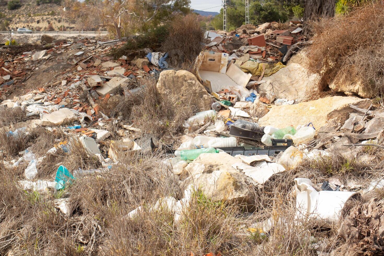 Debris and waste accumulation in an abandoned area of spains coastal region during daylight photo