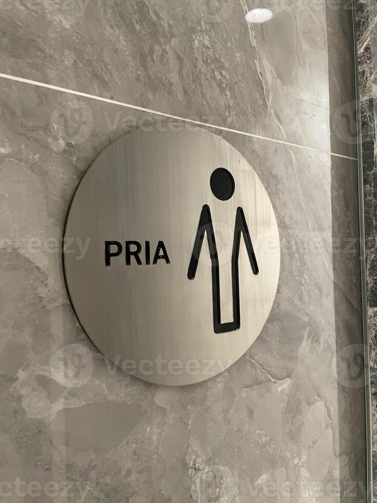 Modern Bathroom Indicator for Gentlemen, Featuring a Minimalist Design and Indonesian Translation photo