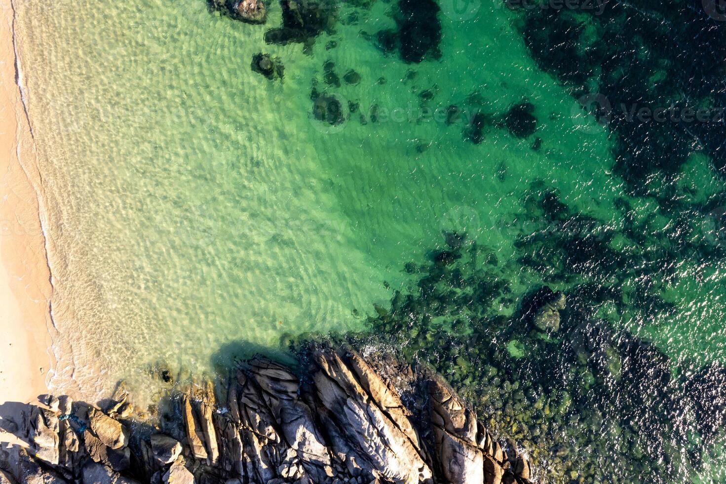 rocks and Emerald Water on a Sunny Day. Aerial top down drone view photo