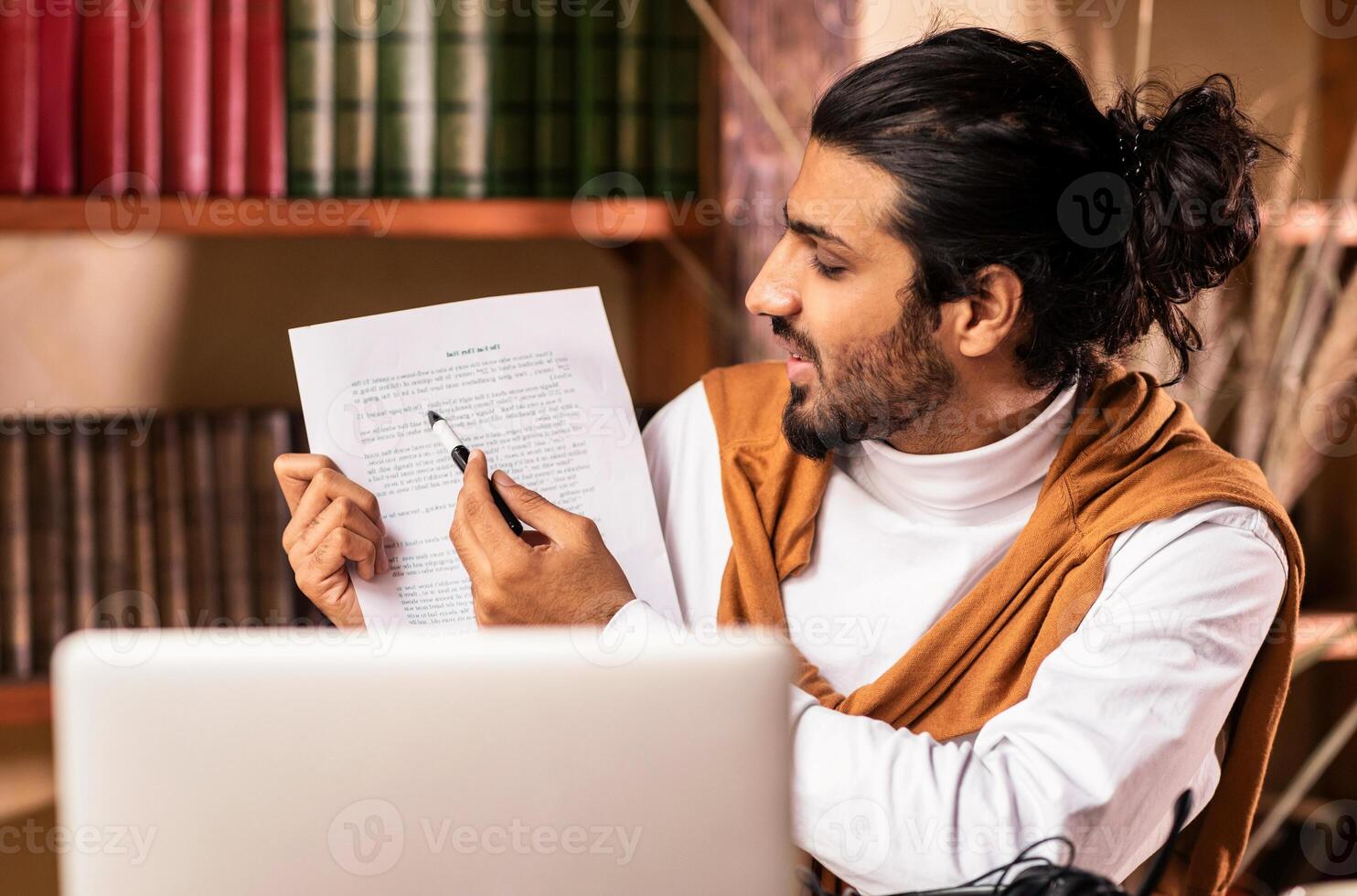 E-Teaching. Arab Teacher Guy At Laptop Computer Having Online Class Webinar With Student Via Call Sitting At Home. Online Tutoring, Distance Education Concept. Selective Focus photo