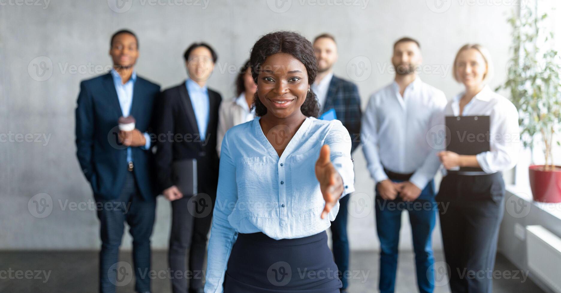 Welcome To Our Team. Black Business Lady Stretching Hand For Handshake Greeting To Camera Making Job Offer Standing In Modern Office. Career, Recruitment And Employment Concept photo