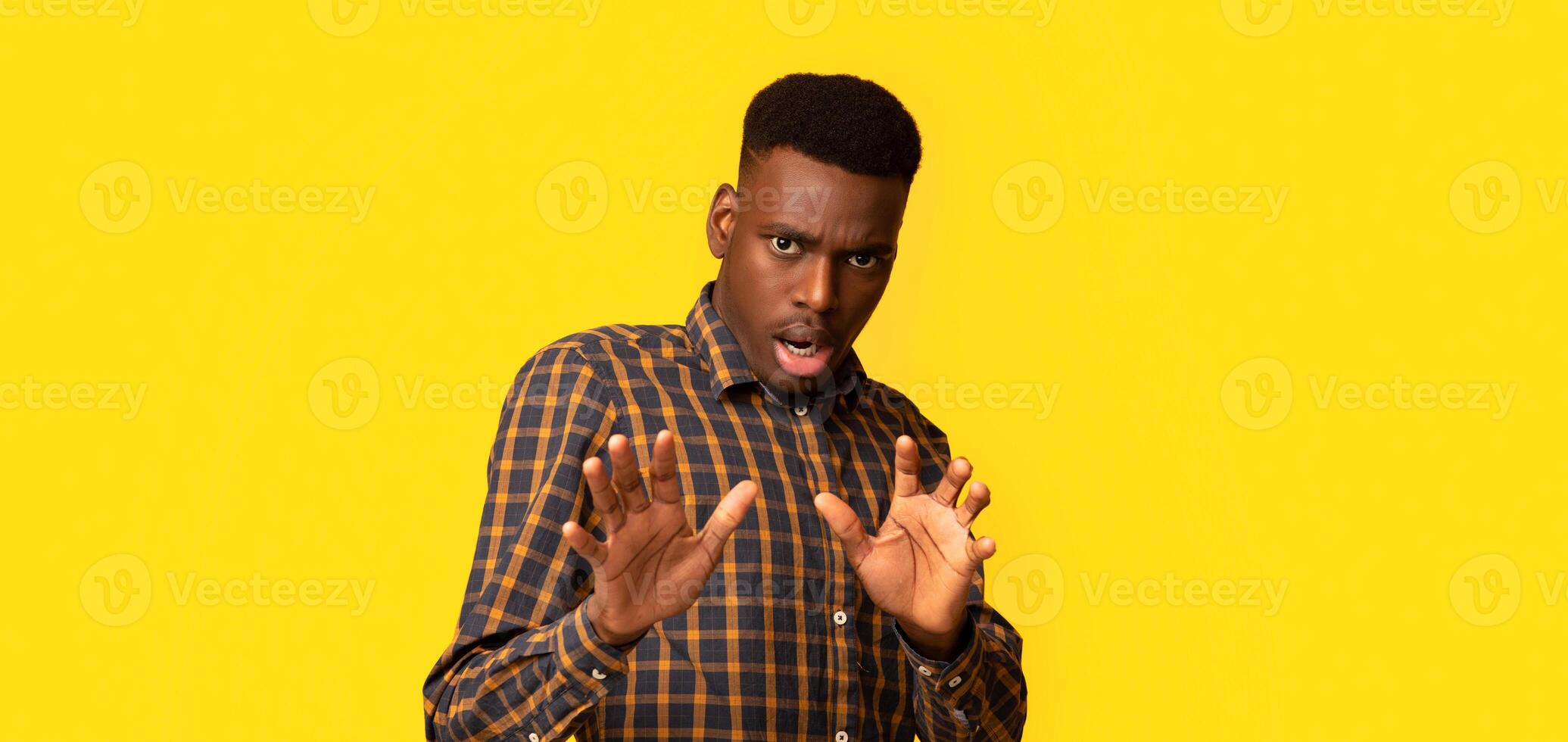 Oh No. Disgusted African American Guy Showing Refuse Gesture With Hands, Frightened Black Man Keeping Away Of Something, Expressing Negative Emotions Over Yellow Studio Background, Copy Space photo