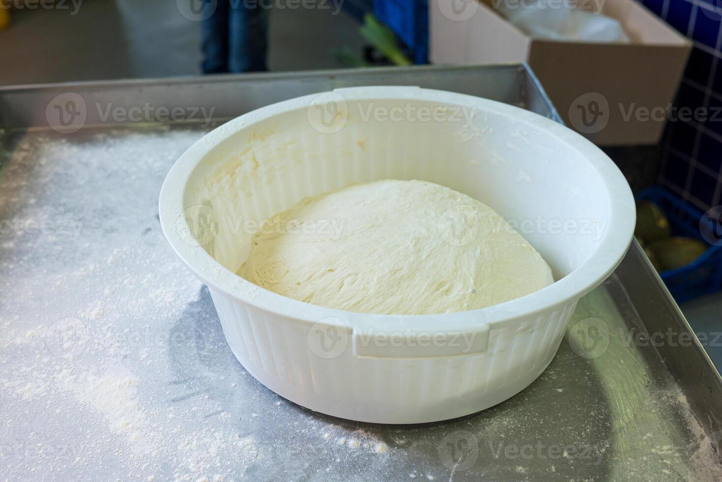 homemade baking concept dough expanding in a bowl during fermentation photo