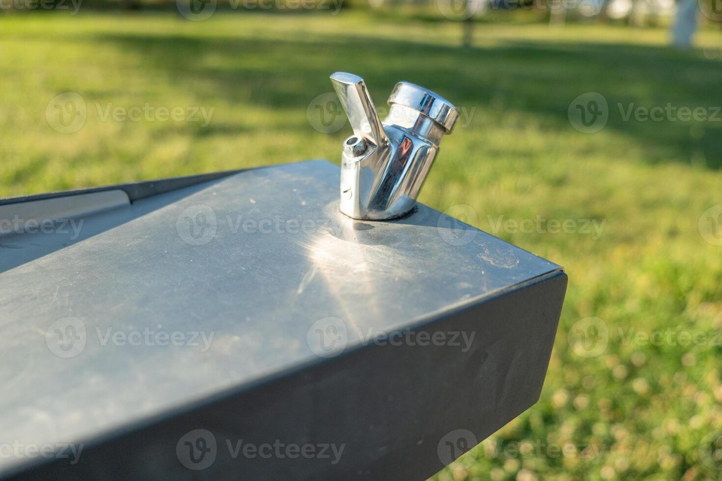 detail of a water spout in a public space modern public water fountain in a park photo