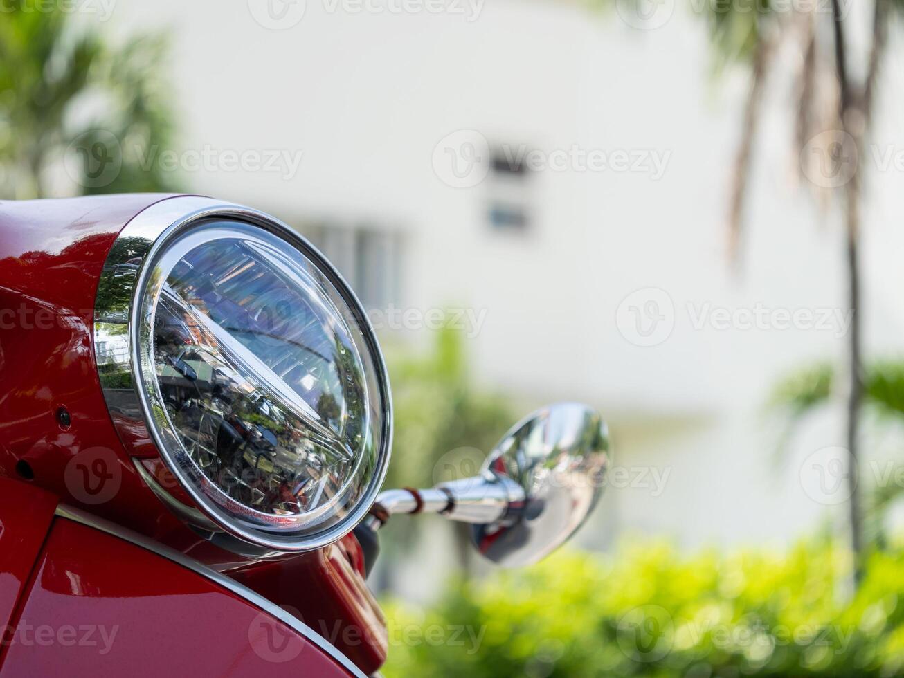 Vibrant red scooter close-up urban setting vehicle daylight artistic perspective photo