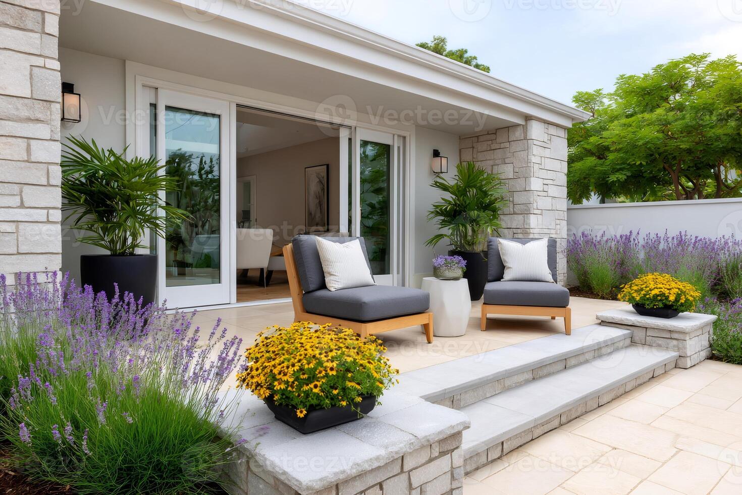 Patio with comfortable seating, lush landscaping, and sliding glass doors opening onto a modern house photo