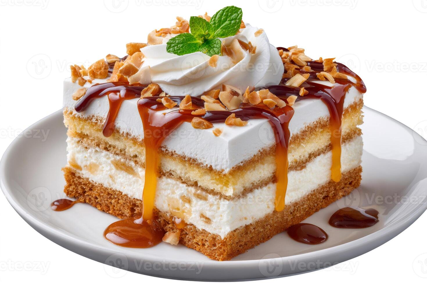 Slice of layered cake with caramel, whipped cream, almonds and mint on white plate photo