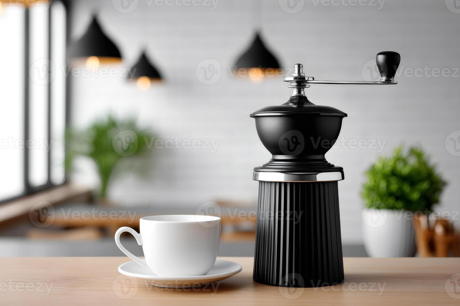 Manual coffee grinder and white cup standing on wooden table in modern kitchen photo