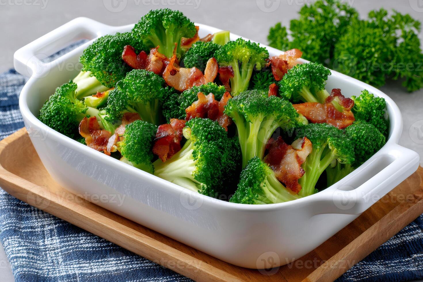 Delicious cooked broccoli with crispy bacon bits in white ceramic bowl photo