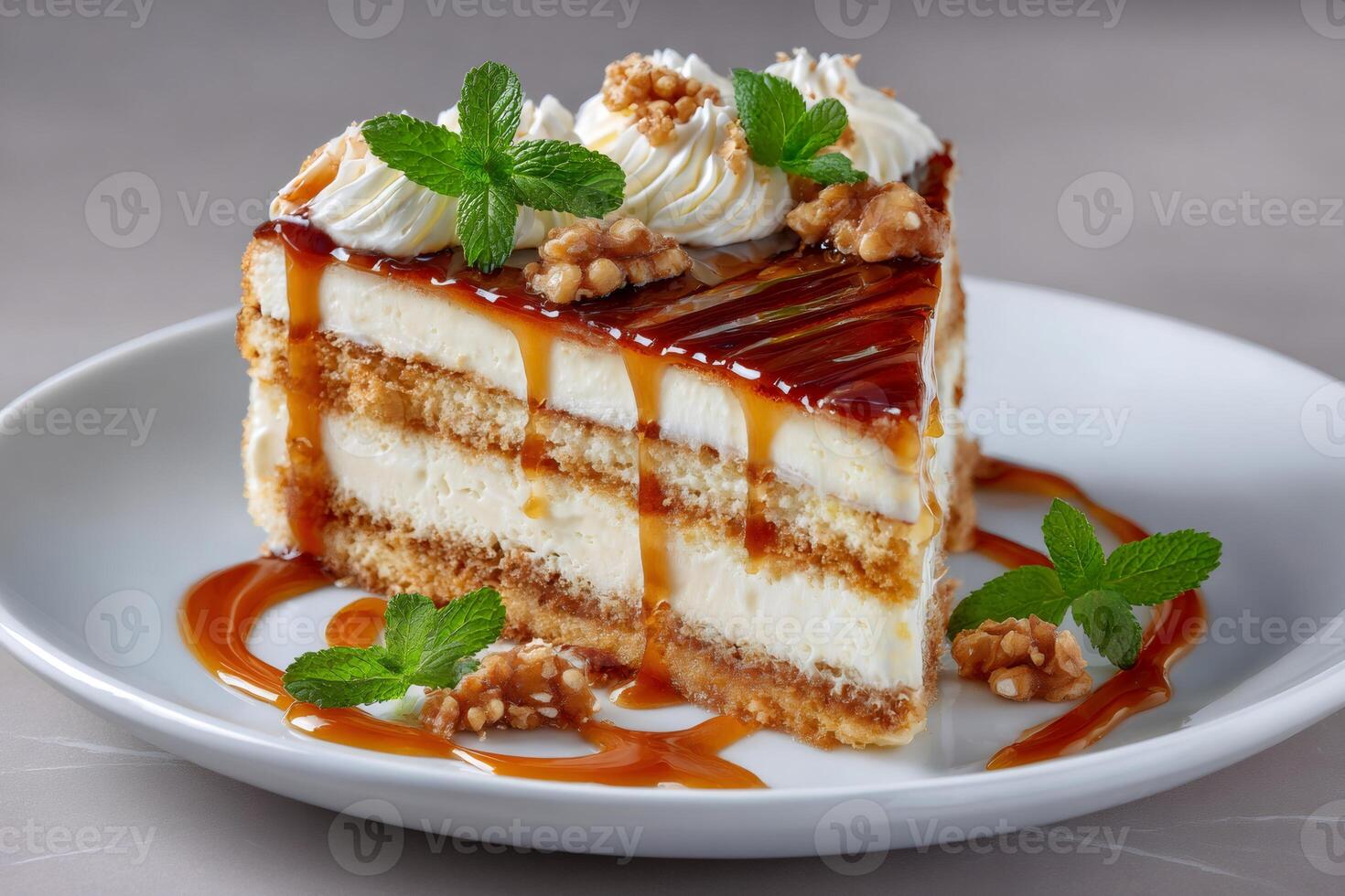 Delicious slice of cake with caramel, walnuts and mint leaves is waiting on white plate photo