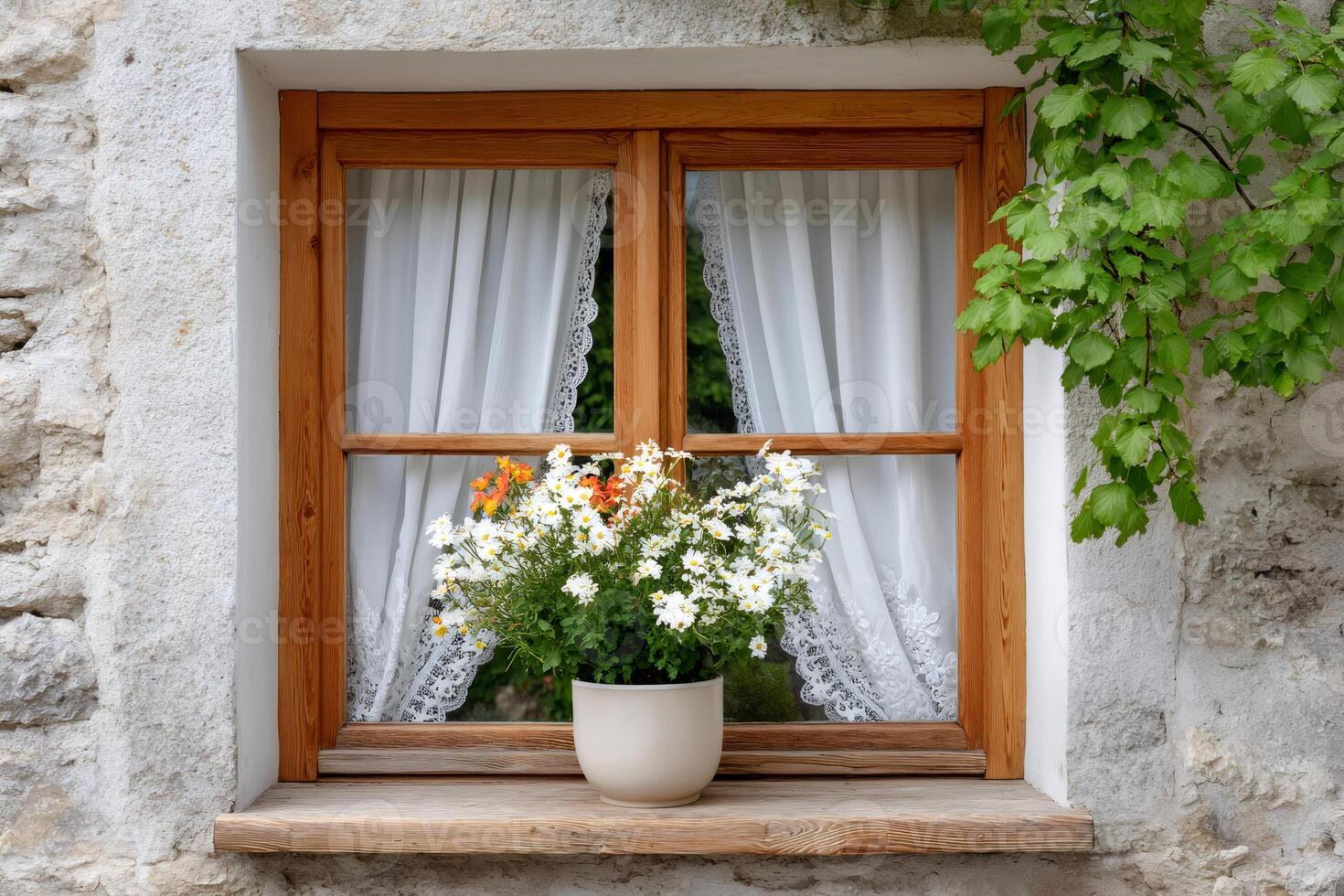 White flowers growing in a pot placed on the windowsill of a wooden window photo
