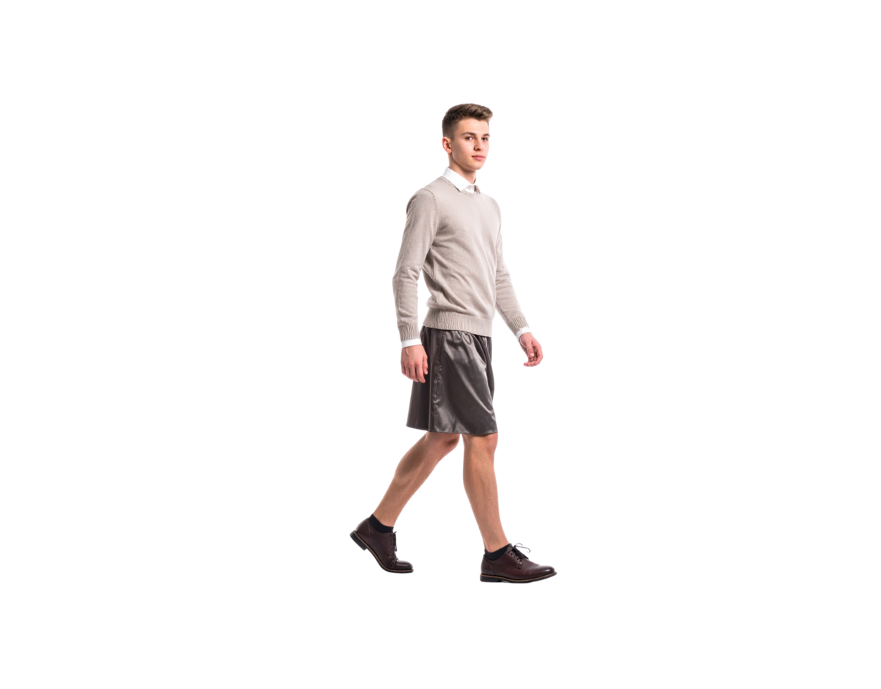 Young Man Walking in Casual Outfit with Leather Shorts and Brown Boots. png