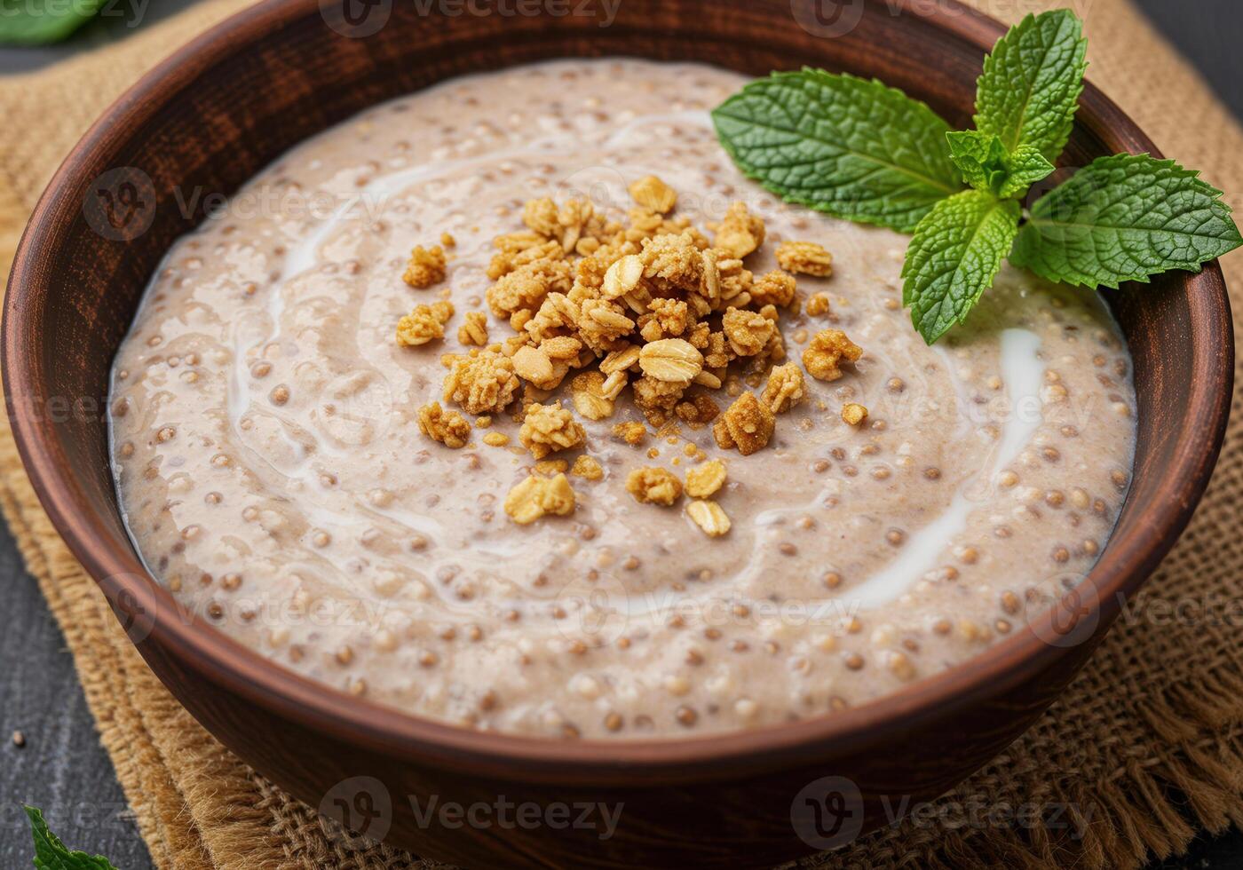 Chia seed pudding with granola and fresh mint in a wooden bowl. photo
